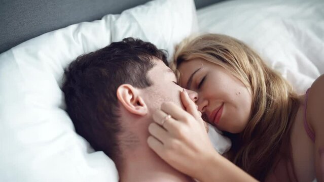 sensual couple embracing in bed. Passionate man and woman enjoying sensual foreplay. Sexy lovers kissing in bedroom in underwear. Relationship and intimate of romantic lovers, sexual activity in happy