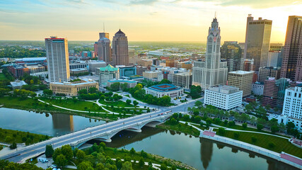 Aerial Scioto River and bridge with park and heart of downtown skyscrapers at sunrise