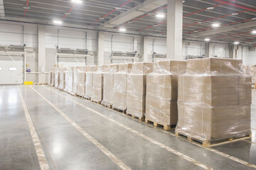 Business distribution and warehouse technology concept background,  Interior of a modern warehouse storage of retail shop. Row of packed boxes ready to ship to the customer