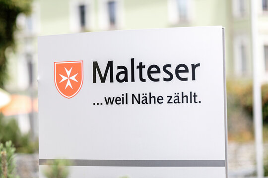 Passau, Bavaria, Germany - 2023 July 23: Sign with Malteser logo and slogan: Beacause closeness matters