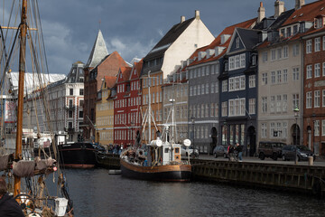 Buildings next to a canal and ships in the water