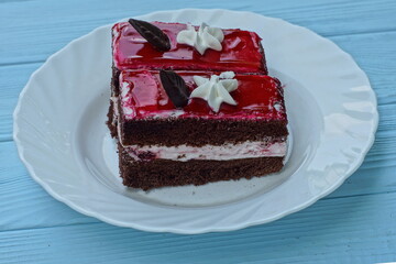delicious fresh red  color with white and brown  cream fragrant sweet sliced cake from a pastry...