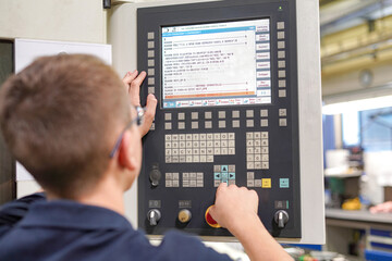 The CNC milling machine programmer makes adjustments to the program to change the cutting parameters.