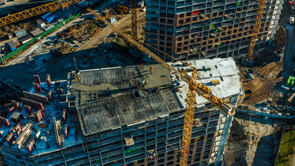 Crane and building construction site against blue sky. 