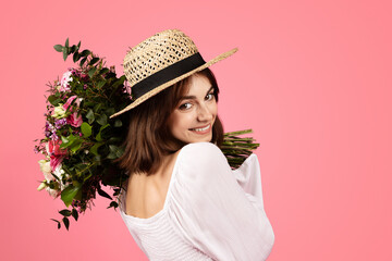 Glad millennial caucasian brunette woman in hat enjoy weekend, bouquet of flowers, holiday celebration