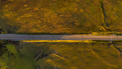 Beautiful highway transportation road scene. California Raodtrip. Highway 1 Aerial panorama at sunset. Muir Woods, San Francisco. Aerial top down view of the road. 