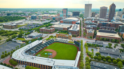 Aerial over Huntington Park baseball diamond early dawn empty streets in city
