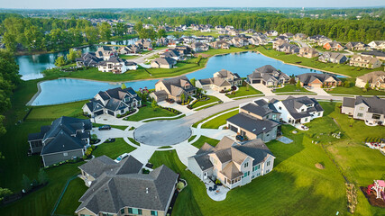 Large pond rich neighborhood cul-de-sac million-dollar homes mini mansions US houses high-end aerial - obrazy, fototapety, plakaty