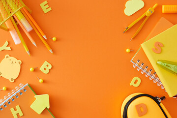 Educational materials for school concept. Top view shot of stationery for the school, yellow letters on orange background with blank space for advert or message