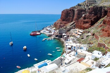 Boats sit docked in the harbor in Santorini, Greece.