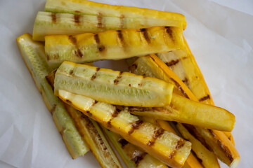 Zucchini slices fried on the grill on a light background