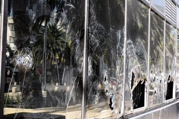 Broken windows of the building. Vanlads smashed the shop window
