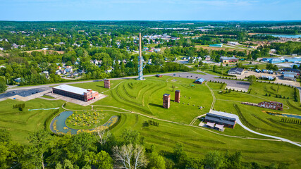 Distant city of Mount Vernon Ohio in drone view of destroyed factory at Ariel Foundation Park trails