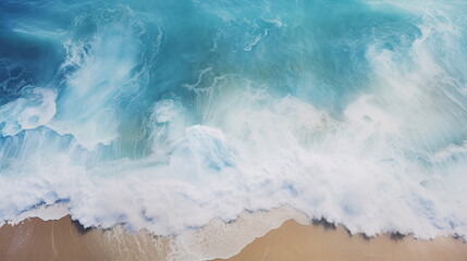 Bird view of blue white ocean waves hitting the beach