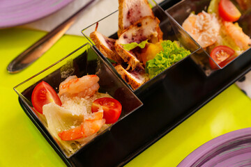 portioned small snacks for a banquet on the festive table. catering