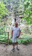 Ukraine, Slavske, Kamenka waterfall.mature man alone outdoors. Male people in front of a waterfall.