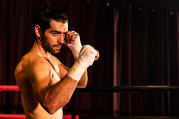 Boxing fighter shirtless posing, caucasian boxer punch his bare fist and wrap in front of camera,...