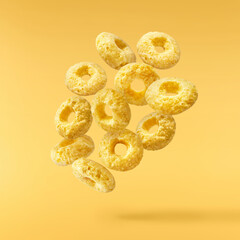 Tasty ring cereals falling in the air isolated.