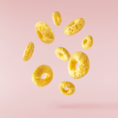 Tasty ring cereals falling in the air isolated.