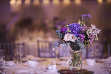 Beautiful Flower decoration of wedding tables. Banquet table setting and decoration. Cutlery on the table. Tables set for an event party. Luxury elegant table setting dinner in a restaurant.