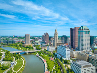 Obraz na płótnie Canvas Aerial Columbus Ohio with river greenway and promenade next to downtown buildings