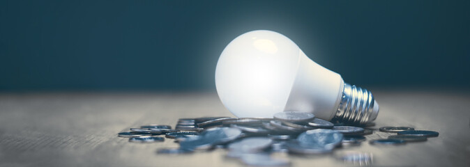 Financial plan or business and saving money idea concept, Lightbulb glowing on stack of coins on...