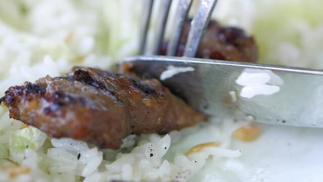  cutting grilled gourmet meats with knife 