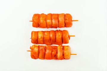Chicken Skewers meat.Fresh raw marinated chicken leg meat skewers without skin on a white...