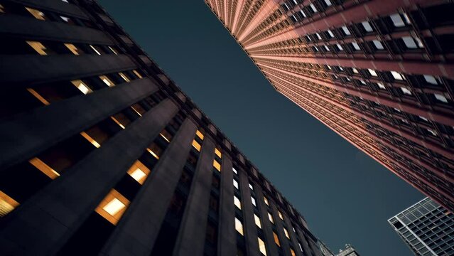 High-rise buildings with modern architecture in a big city. Seamless looping animation. Bottom view of skyscraper buildings.  60 frames per second video. 