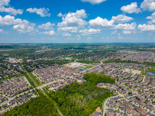 Discover the essence of picturesque living in Stouffville, Whitchurch-Stouffville, Ontario, through captivating drone photos of a residential area. Blue skies and green grass of summertime accentuate 