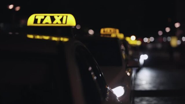 Yellow taxi cab and blurred city lights background at night with colorful bokeh