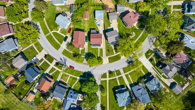 Downward view circle road in neighborhood with houses in summer aerial HOA