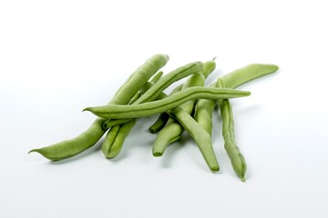 Raw green beans on white background.