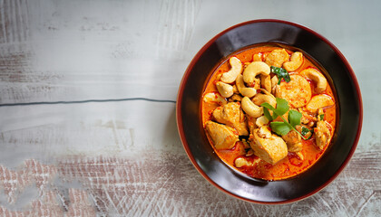 Chicken and cashew red curry, thai inspired dish overhead view with copy space