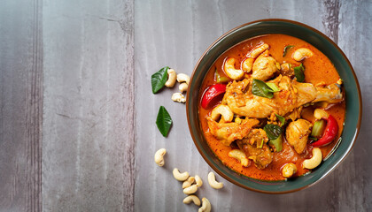 Chicken and cashew red curry, thai inspired dish overhead view with copy space