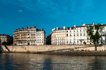 Fototapeta na wymiar Paris, France. April 24, 2022: City architecture with houses and Seine river view