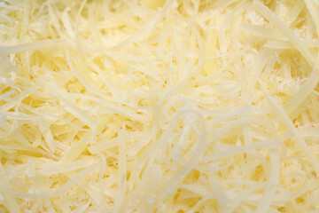 close up of food. close up of cheese. grated cheese texture. cheese details.
