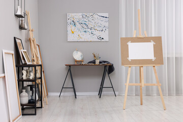 Artist's studio with easels, canvases and painting supplies