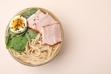 Delicious ramen with meat on beige background, top view and space for text. Noodle soup