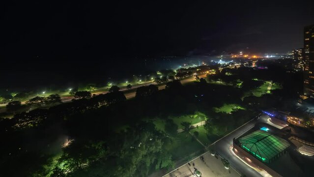 Panning up aerial time lapse of random fireworks being shot off and smoke floating by on the lakefront for the July 4th Independence day celebration in Chicago.