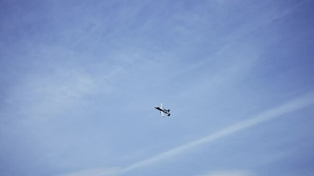 An Air Force A-10 Warthog Thunderbolt II plane attack jet flying on blue sky, slow motion
