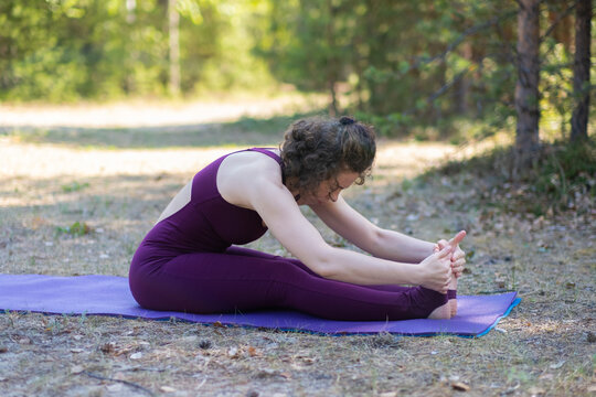 Young woman doing yoga outdoors in the park