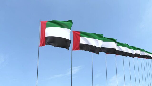 Looping video of United Arab Emirates flag Waving on blue sky background, Animation of United Arab Emirates flag