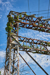 Power lines, electrical tower, wires, abandoned, decaying, blue sky, white clouds