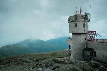 Building at Mount Washington Observatory and mountain view with dark stormy clouds, Jackson, New Hampshire
