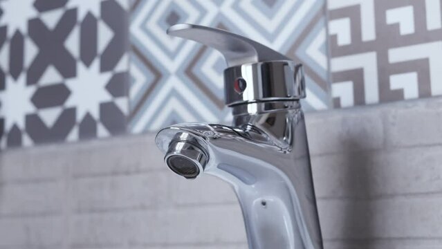 Water dripping from faucet tap at Bathroom