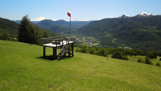 Drone view of Chilean flag and Villarica volcano in the beginning of route to Heart lagoon laguna corazon in Chile.