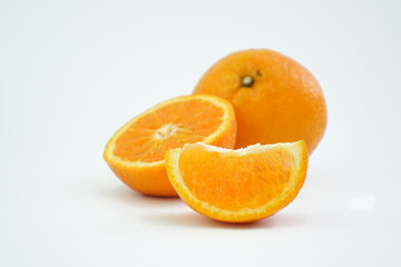 Naklejka na ściany i meble Group of oranges cut in half and pieces isolated on white background with shadow. Clipping path. Orange for commercial use product 