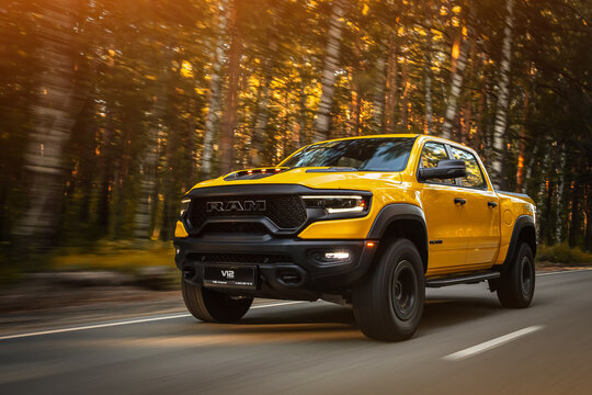  Novosibirsk, Russia - June  01, 2023:  yellow Dodge Ram Trx Havok Edition driving on road  on a warm summer day against the backdrop of  forest