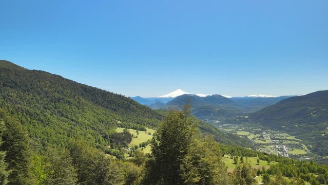 Drone view of Chilean flag and Villarica volcano in the beginning of route to Heart lagoon laguna corazon in Chile.
